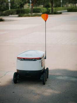 Autonomous delivery robot navigating an outdoor setting, showcasing modern technology and innovation.